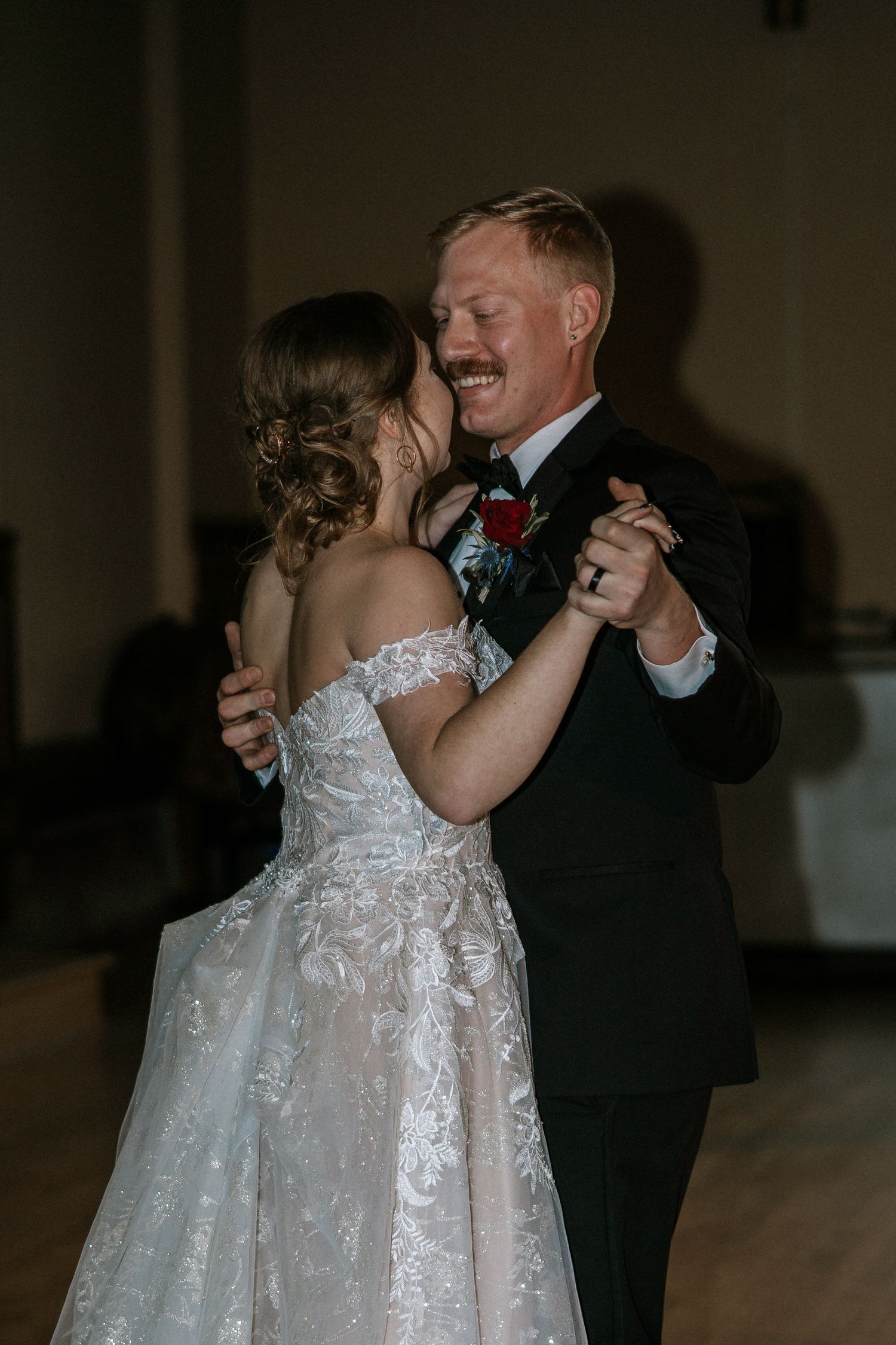 Groom with mustache tenderly holds bride close during romantic first dance at wedding at Urban Artifact in Cincinnati, Ohio