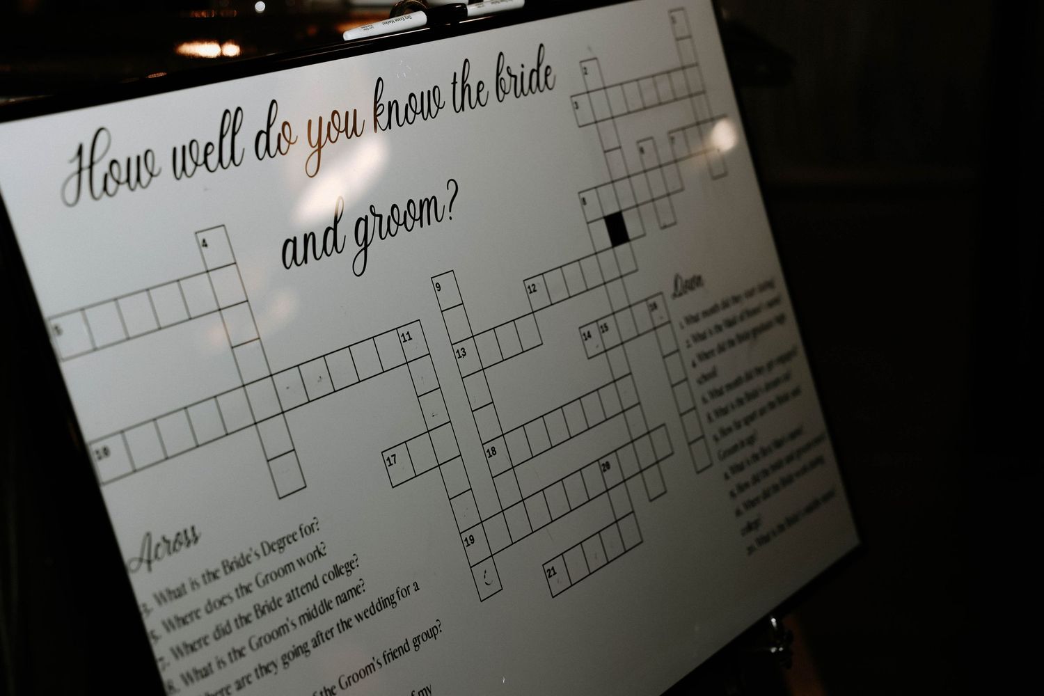 Wedding crossword puzzle game board asking how well guests know the bride and groom.