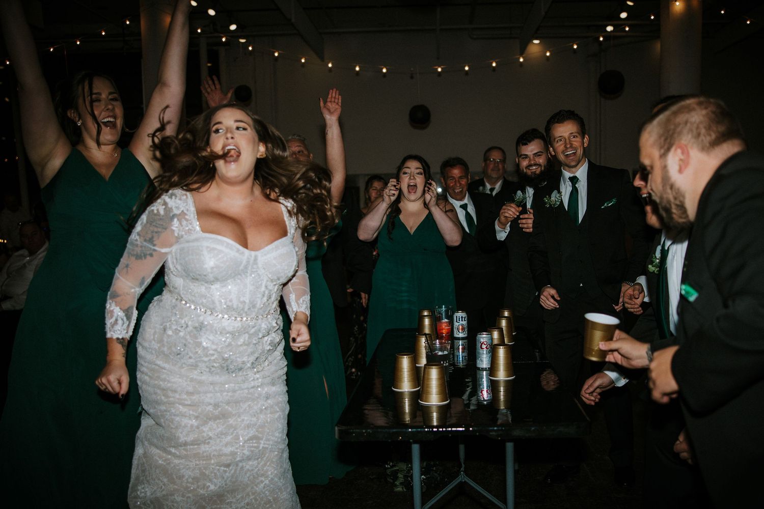 Bride dancing and celebrating with wedding party at lively indoor reception at The Red Space in Cleveland, Ohio