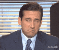 Steve Carell as Michael Scott from The Office making a pouty disapproving face, wearing a suit, Peacock TV.