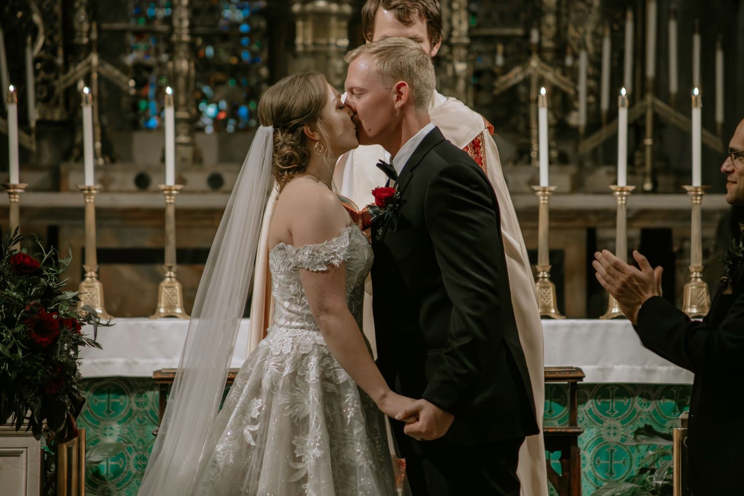 Bride and groom share their first kiss at the altar in a stunning church wedding ceremony in Cincinnati, Ohio