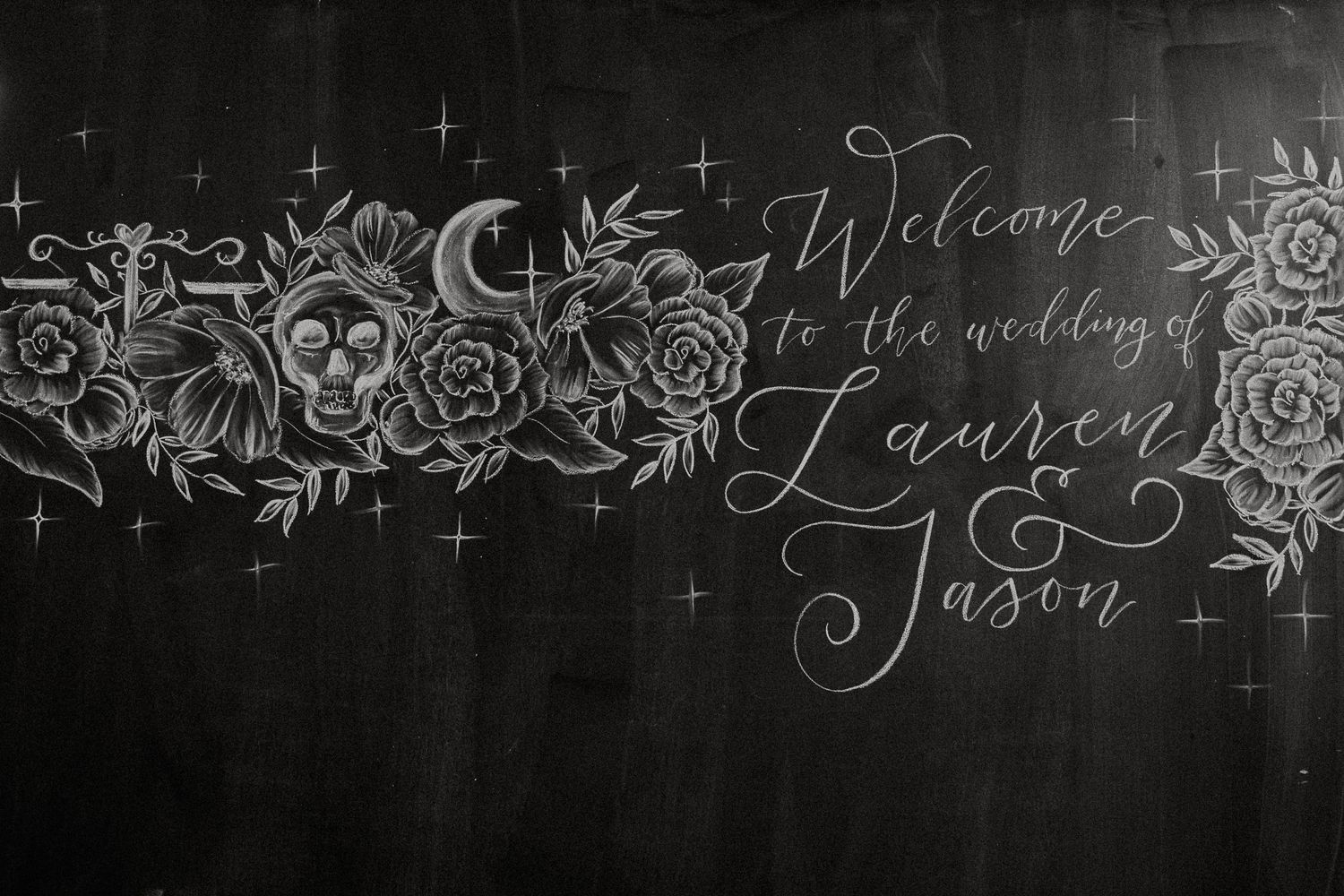 Chalkboard wedding welcome sign with skull and floral art reading Welcome to the wedding of Lauren and Jason.