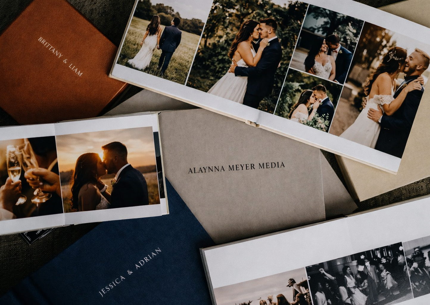 Collection of elegant wedding photo albums and prints from Alayna Meyer Media photography studio.