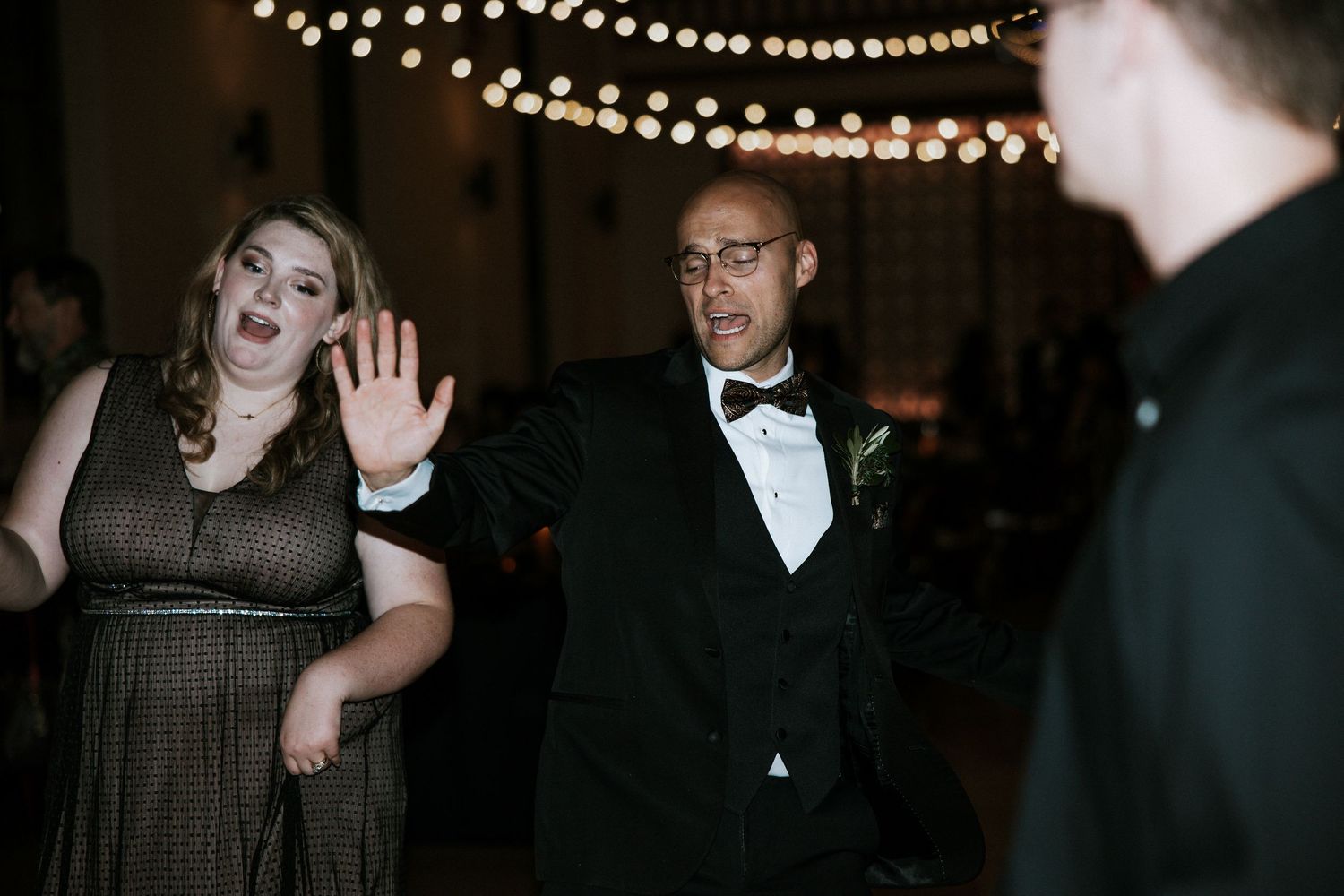 Wedding guests in formal attire dancing and celebrating at evening reception in Cincinnati, Ohio