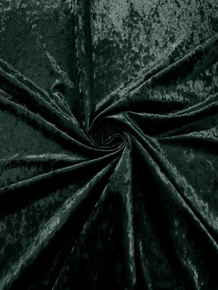 Dark green crushed velvet fabric with a swirling spiral pattern showing rich texture and luxurious sheen.
