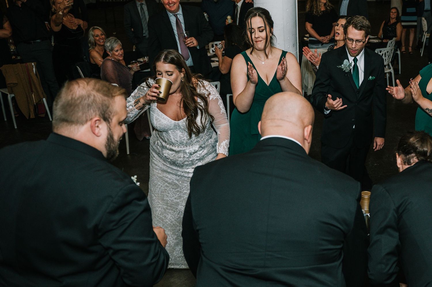 A wedding guest dances energetically on the dance floor during a lively reception celebration at The Red Space in Cleveland, Ohio