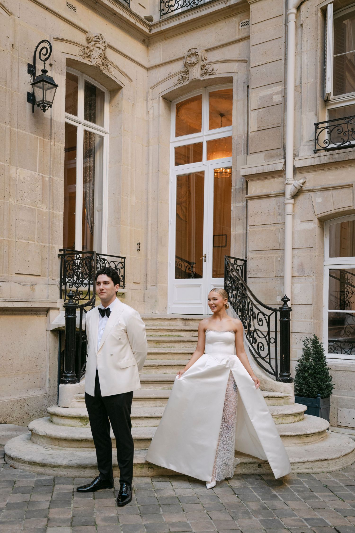 A sequence of four wedding photos showing a couple and their dog at an elegant stone mansion entrance.