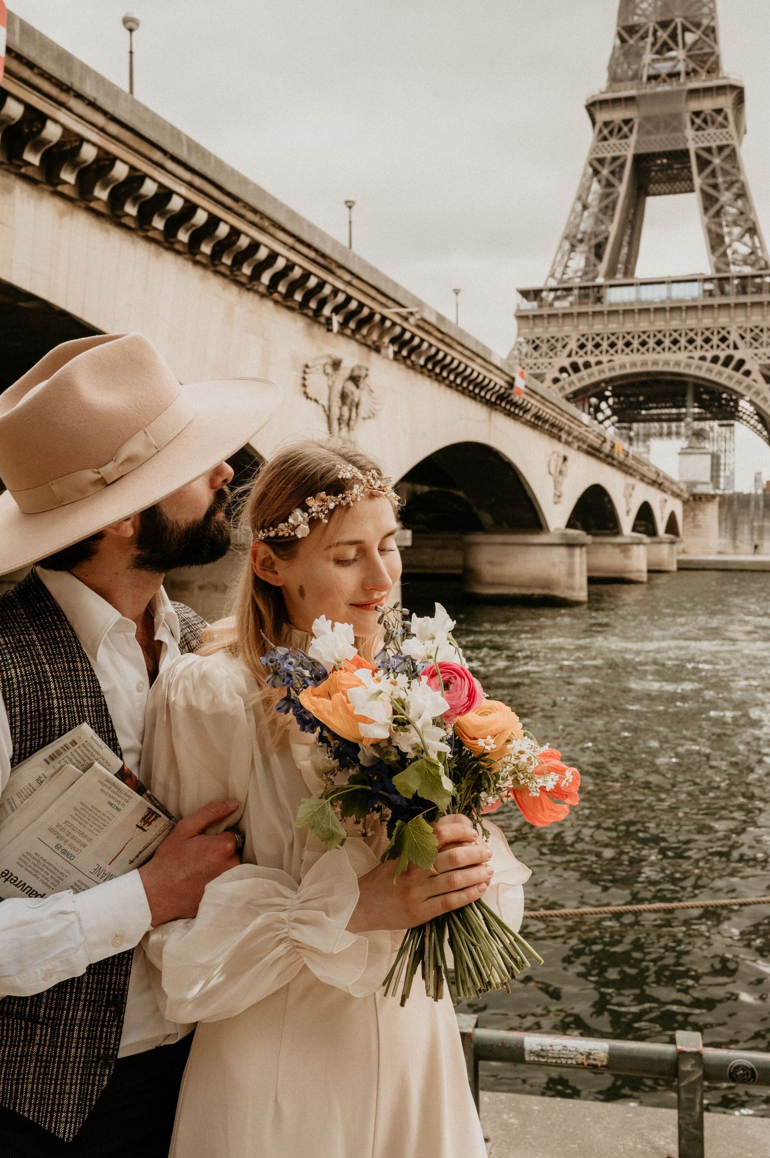 A romantic vintage-style photoshoot by the Seine river with the Eiffel Tower in the background.