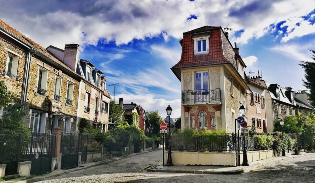 Quaint residential street corner in Paris featuring historic buildings and traditional architecture.