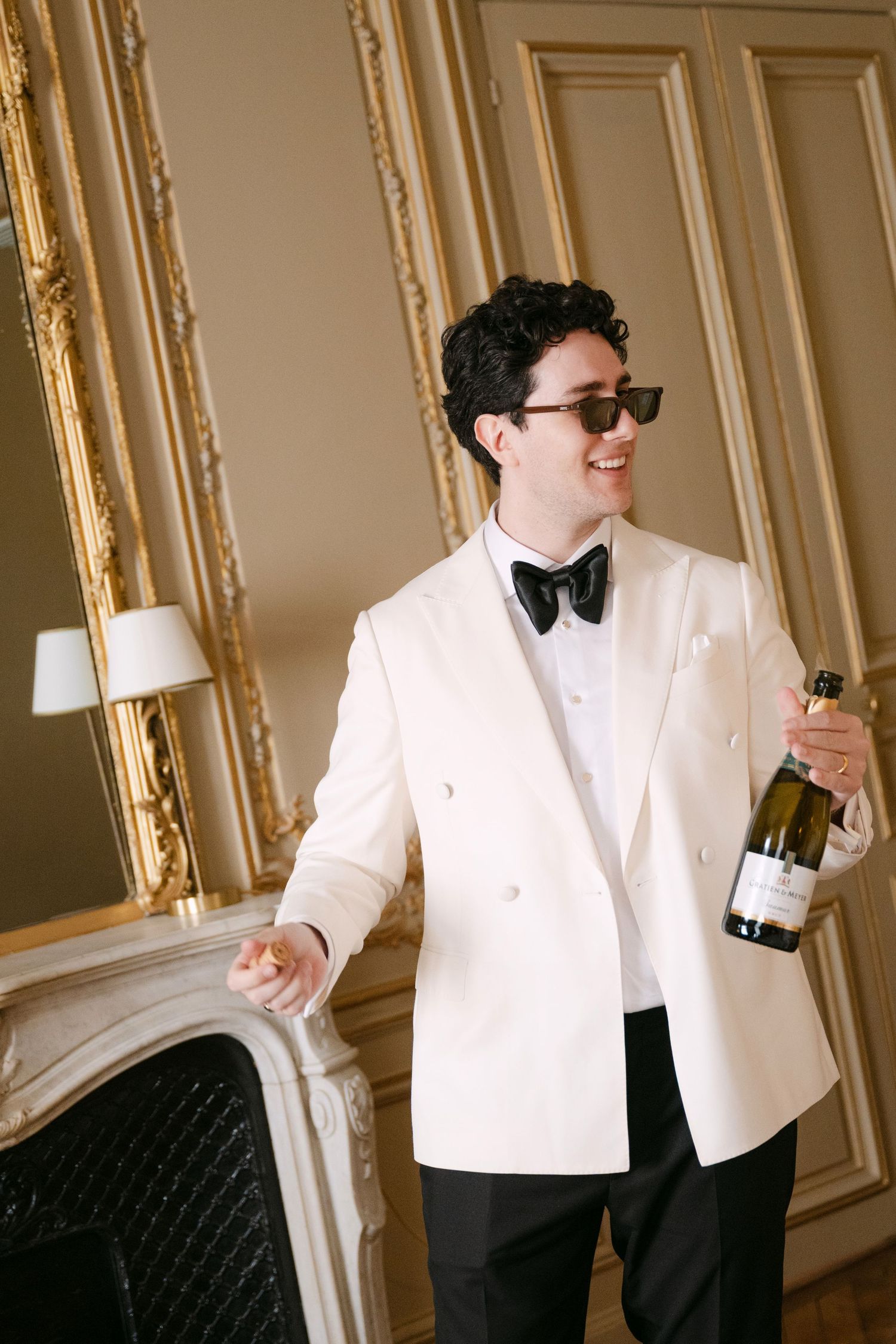 A sequence of four photos shows someone in a white tuxedo jacket dancing and celebrating with a champagne bottle.