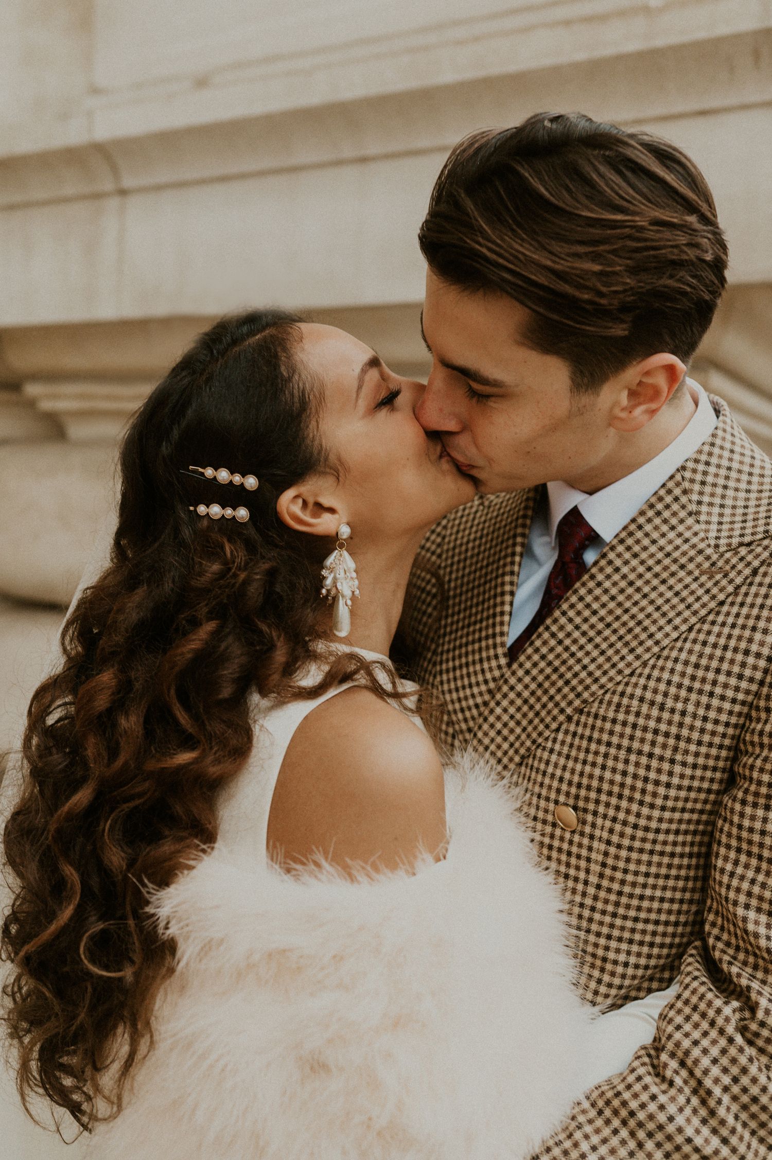 Intimate wedding kiss captured in warm vintage tones.