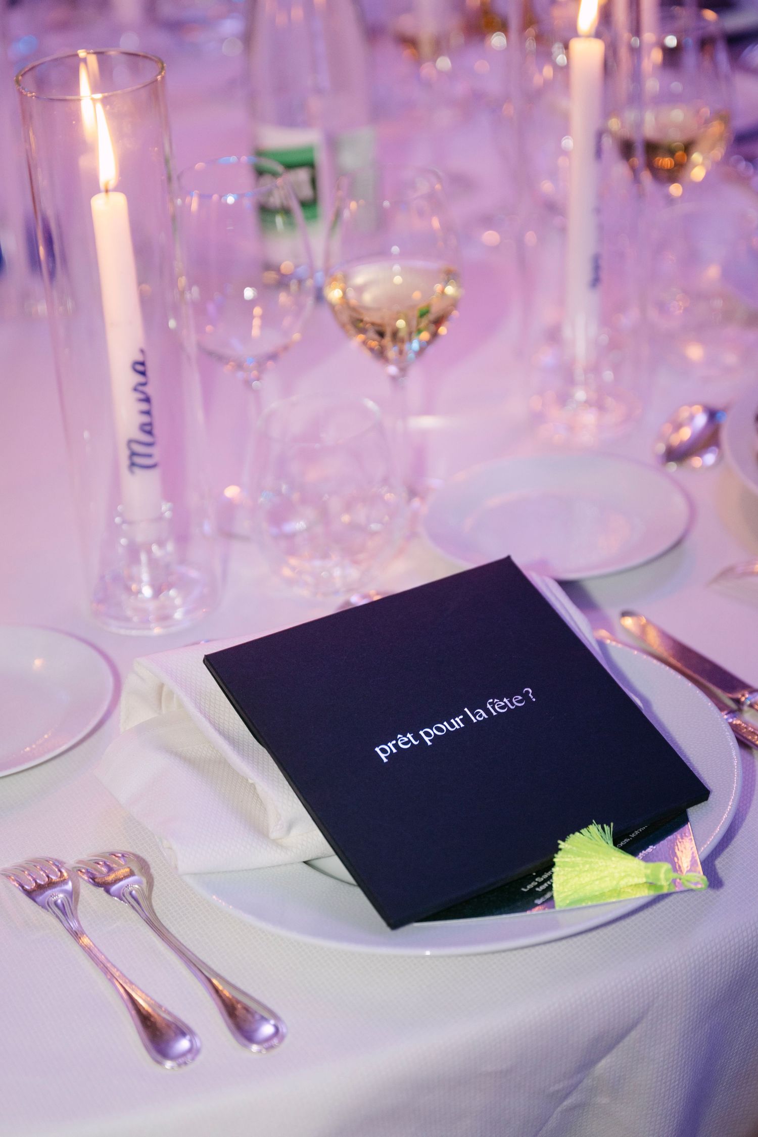 Elegant black wedding menu card reading prêt pour la fête on white reception table setting.