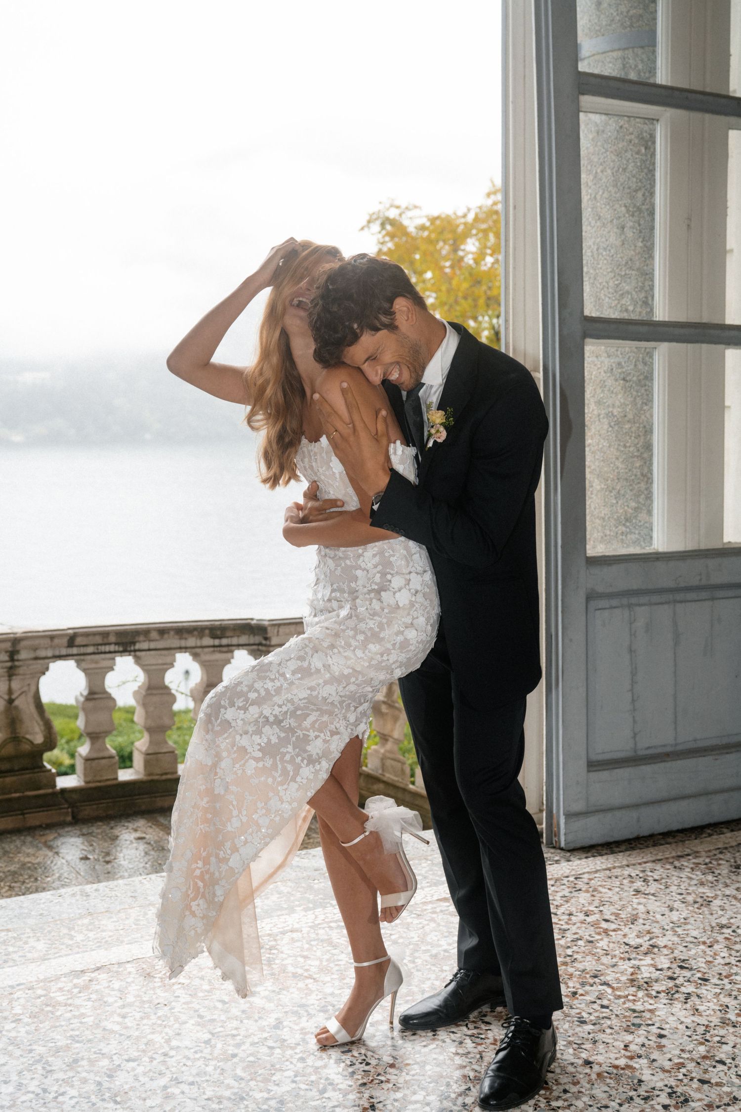 A romantic proposal moment overlooking a coastal mountain landscape with misty views of the Mediterranean Sea below.