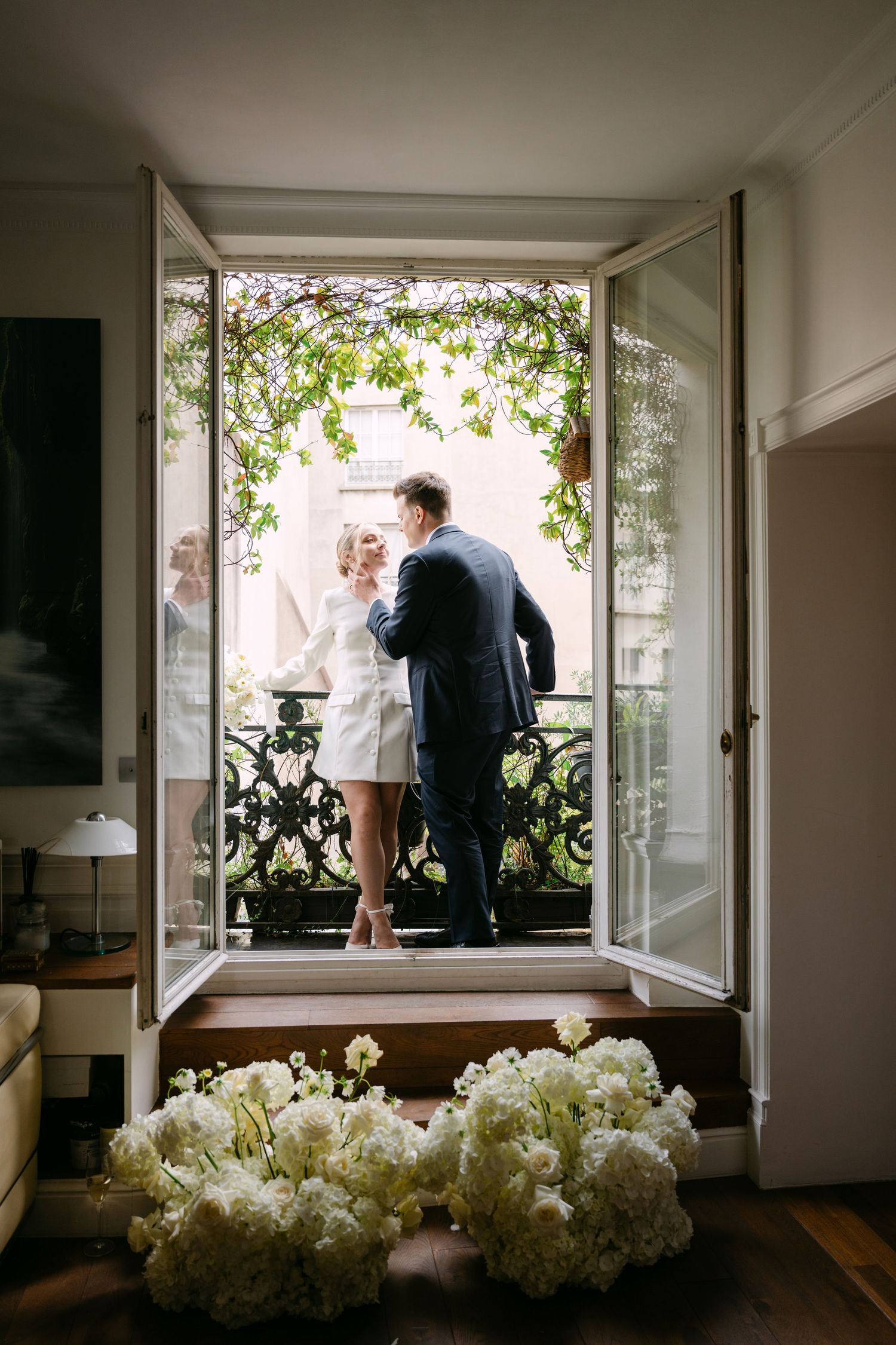 A series of artistic photos showing people by a window with white hydrangea flowers in the foreground.
