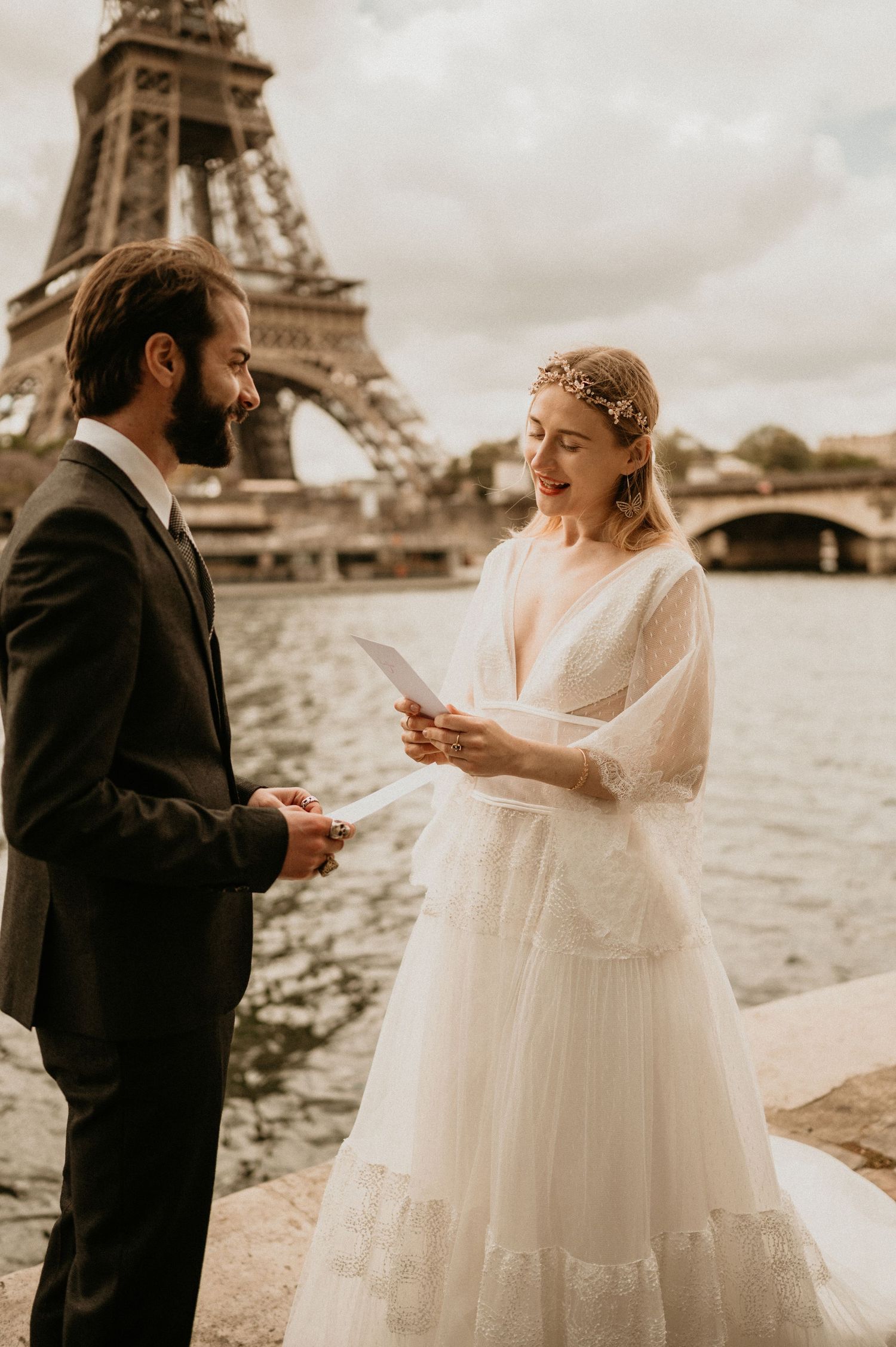 Intimate Paris wedding moment as couple exchanges personal vows by Seine River.