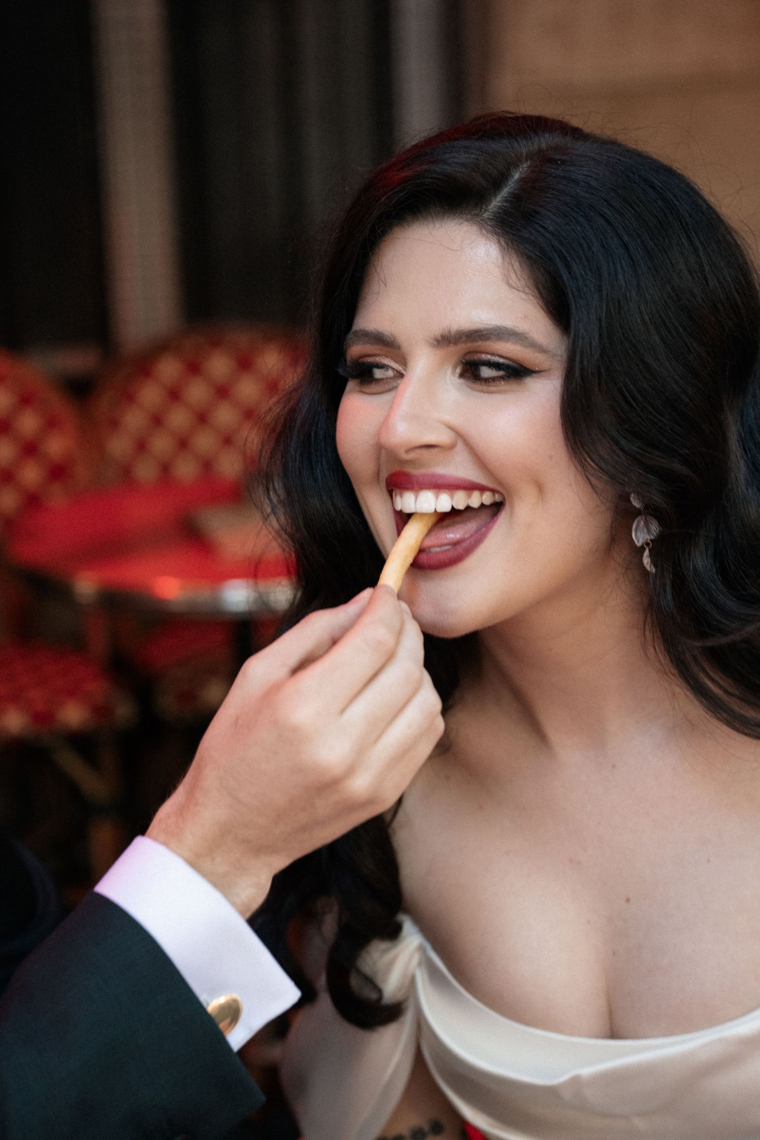 Close-up sequence of a couple playfully feeding each other at their wedding celebration.