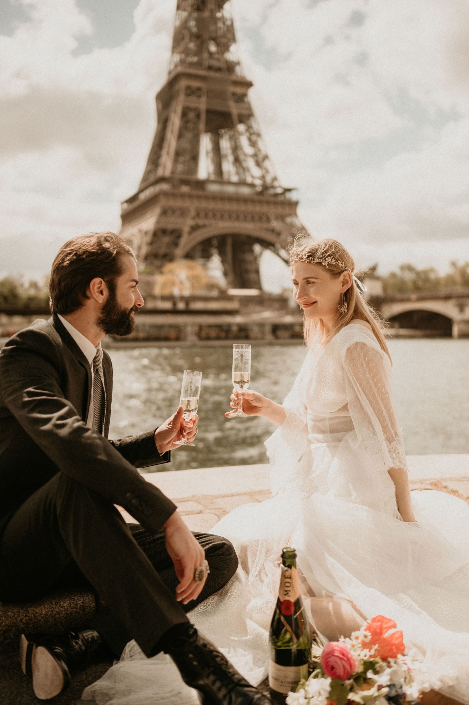 Champagne toast during a romantic Paris wedding photoshoot with the Eiffel Tower in view.