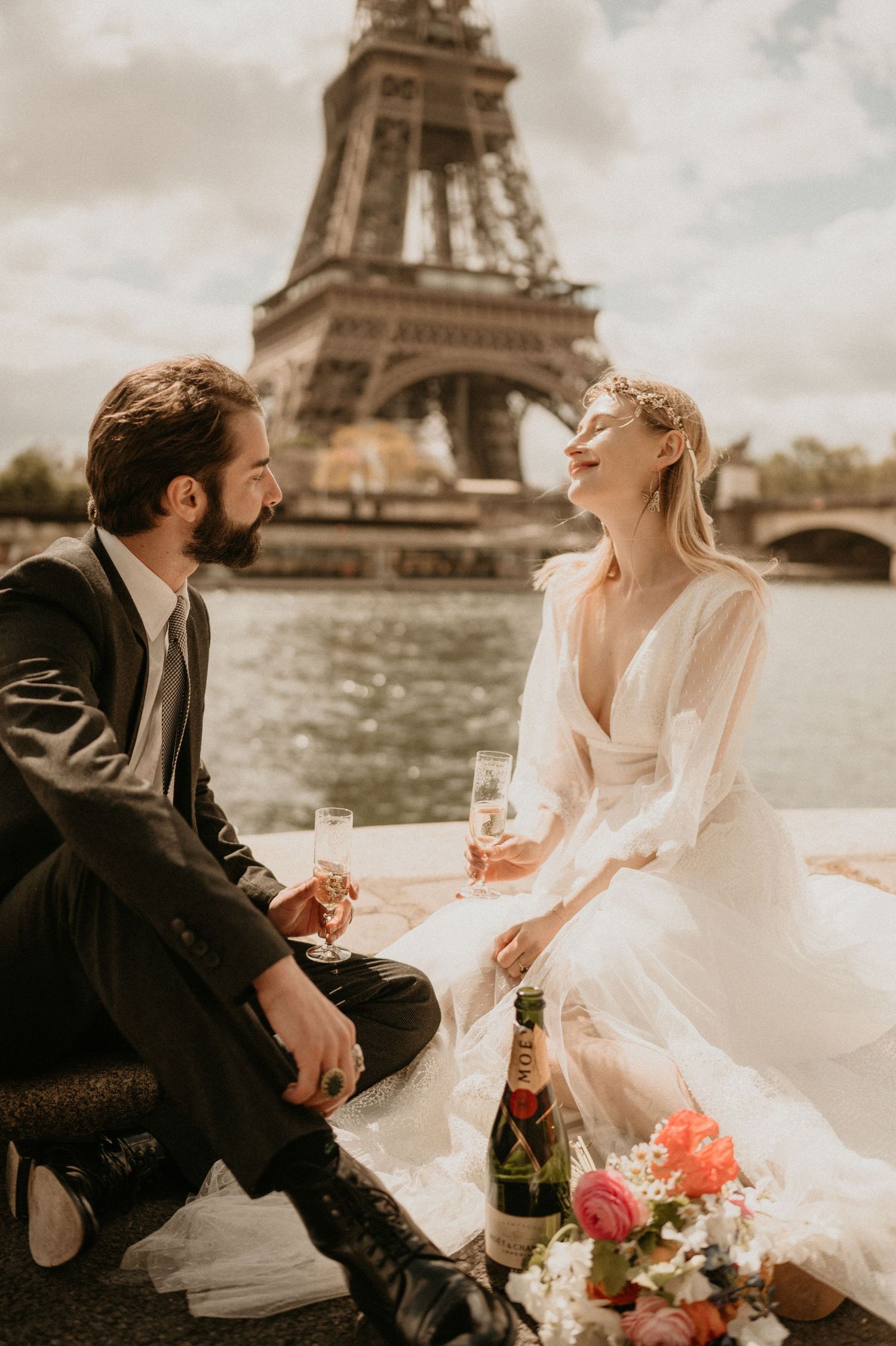 A joyful wedding moment captured by the Seine River with the iconic Eiffel Tower backdrop.
