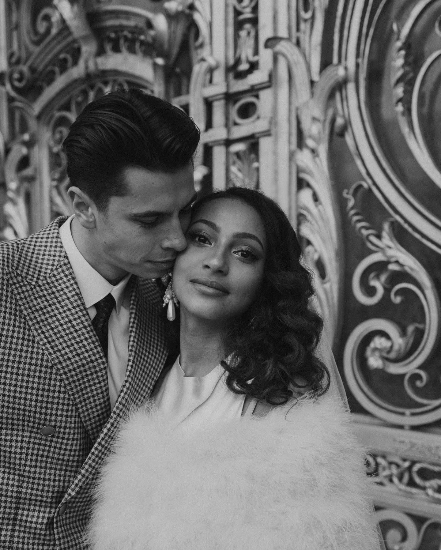 Elegant black and white fashion portrait with ornate architectural backdrop in Paris.
