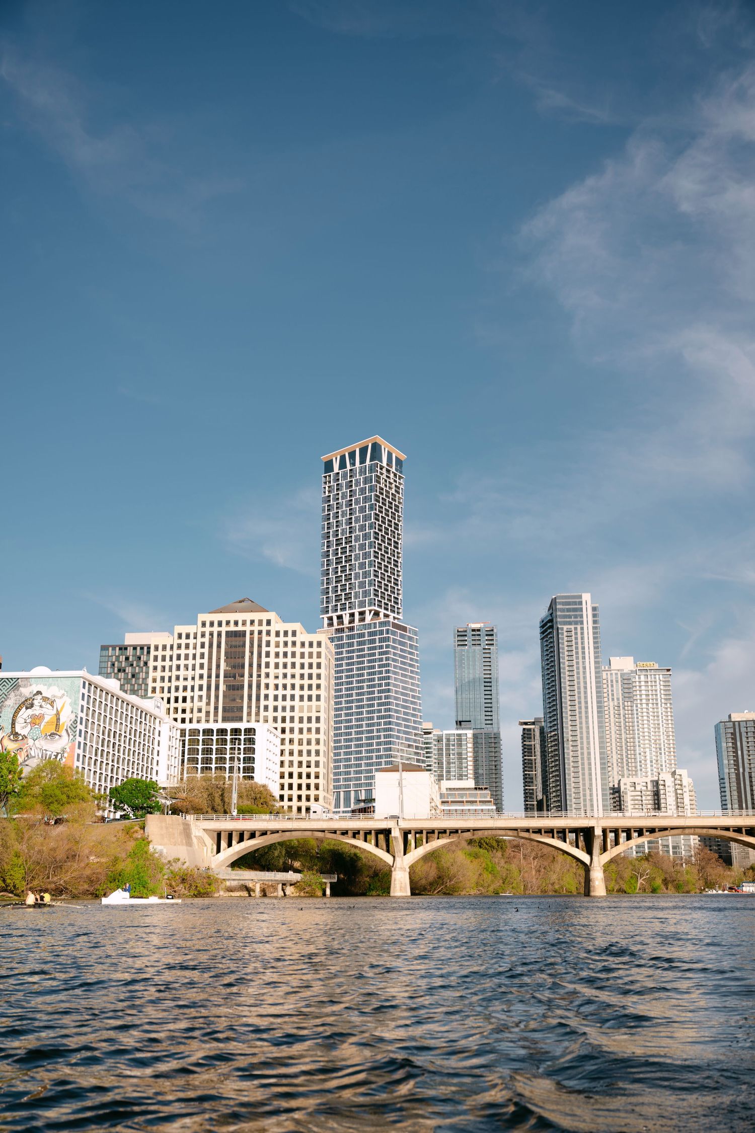 Austin Texas downtown skyline with bridge and Lady Bird Lake on a sunny day.
