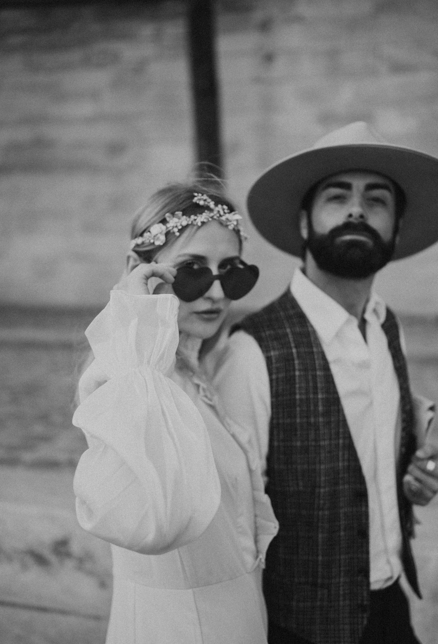 A black and white close-up portrait of a couple in vintage wedding attire.