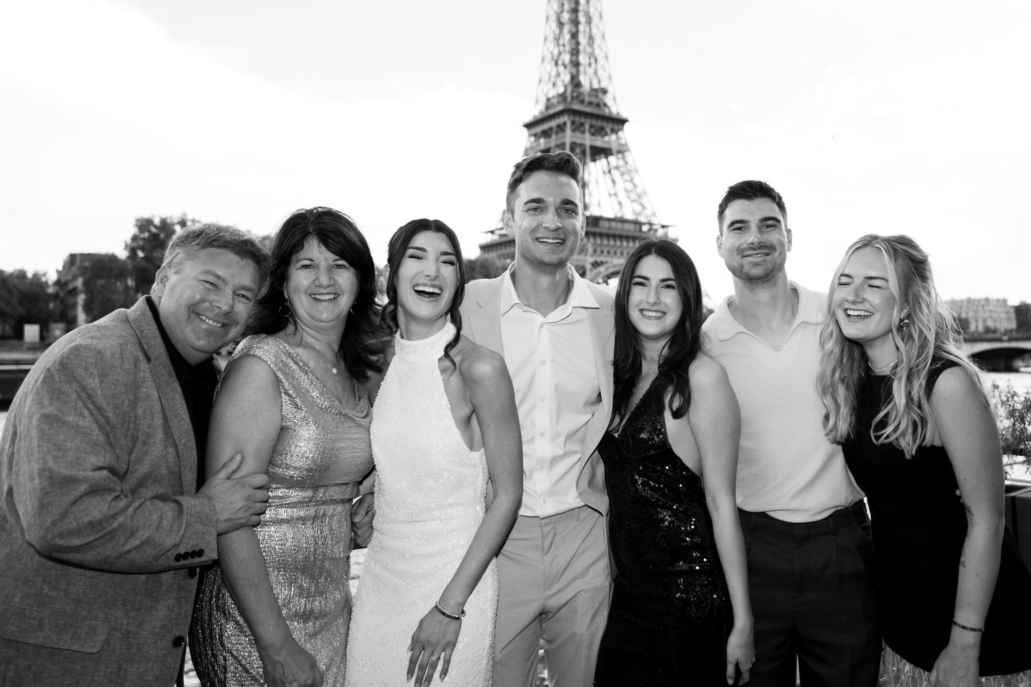 A collage of black and white photos showing groups of people posing together outdoors and indoors.