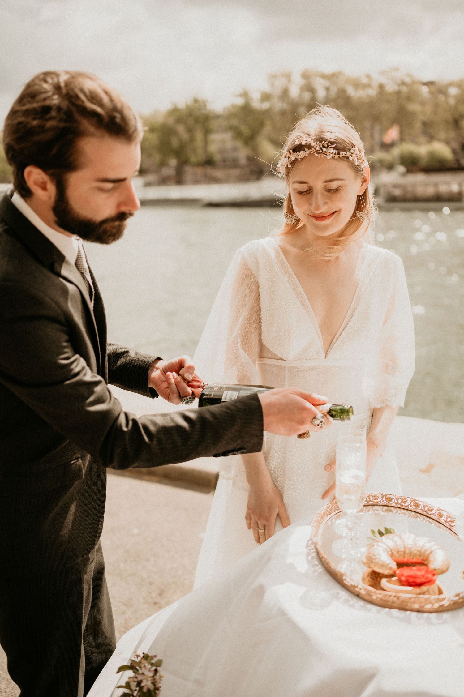 Newlyweds share an intimate moment while cutting cake at their outdoor wedding reception.