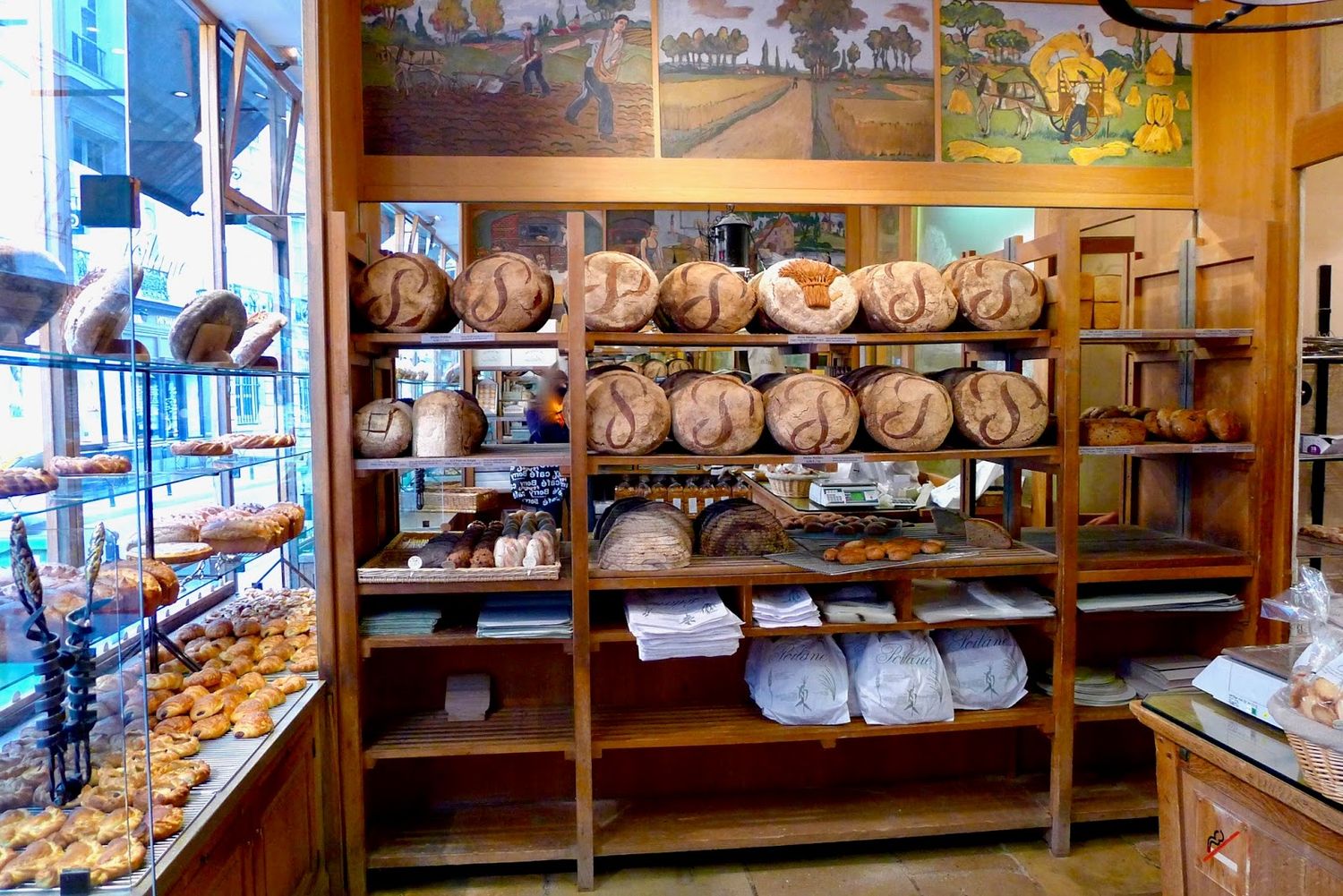 Traditional French bakery shelves stocked with fresh baguettes and assorted breads.