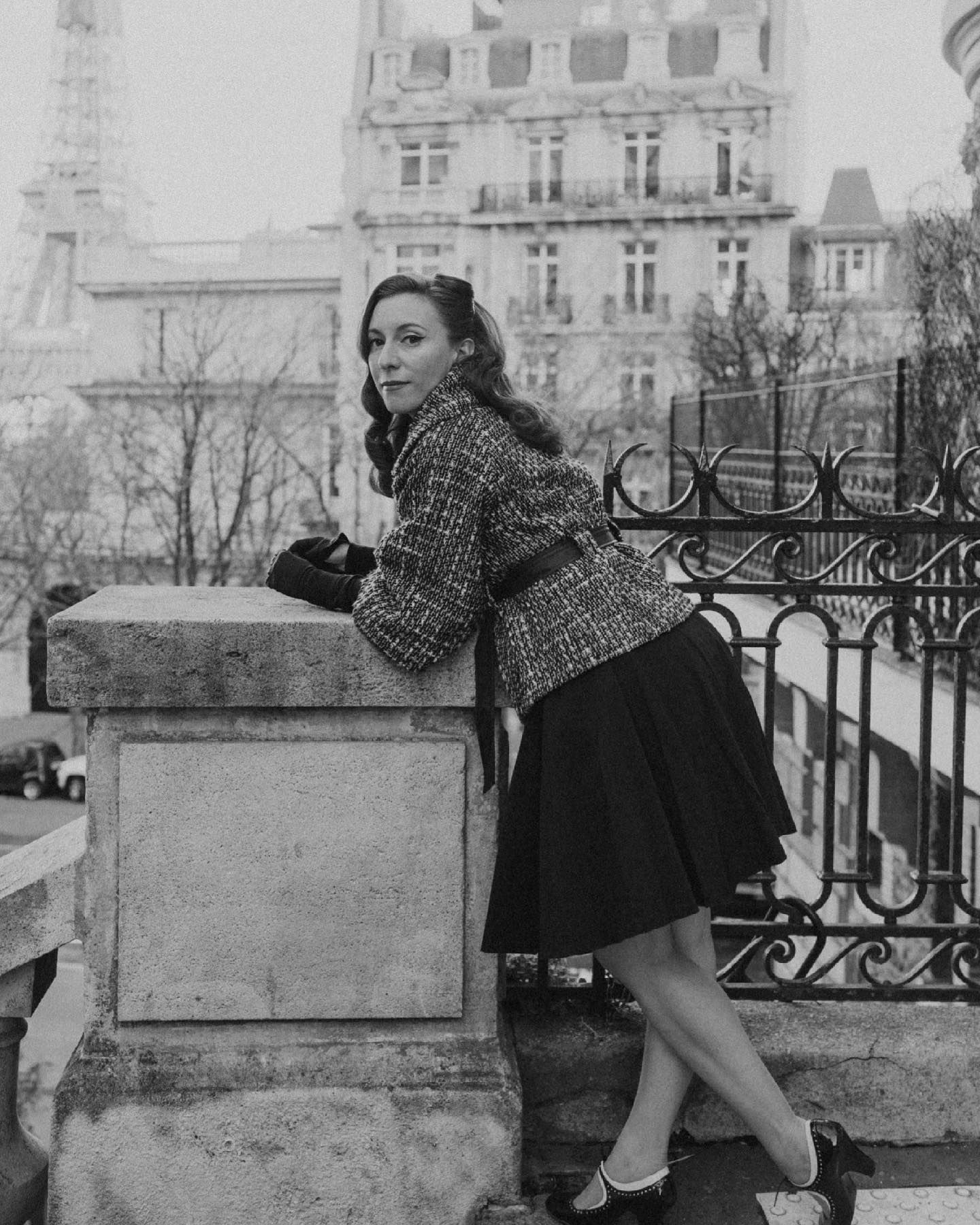Vintage black and white photograph with Eiffel Tower visible in background.