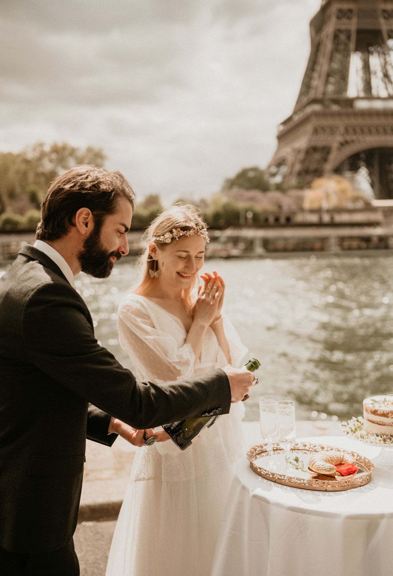 A romantic champagne toast during a Paris elopement with the Eiffel Tower backdrop.