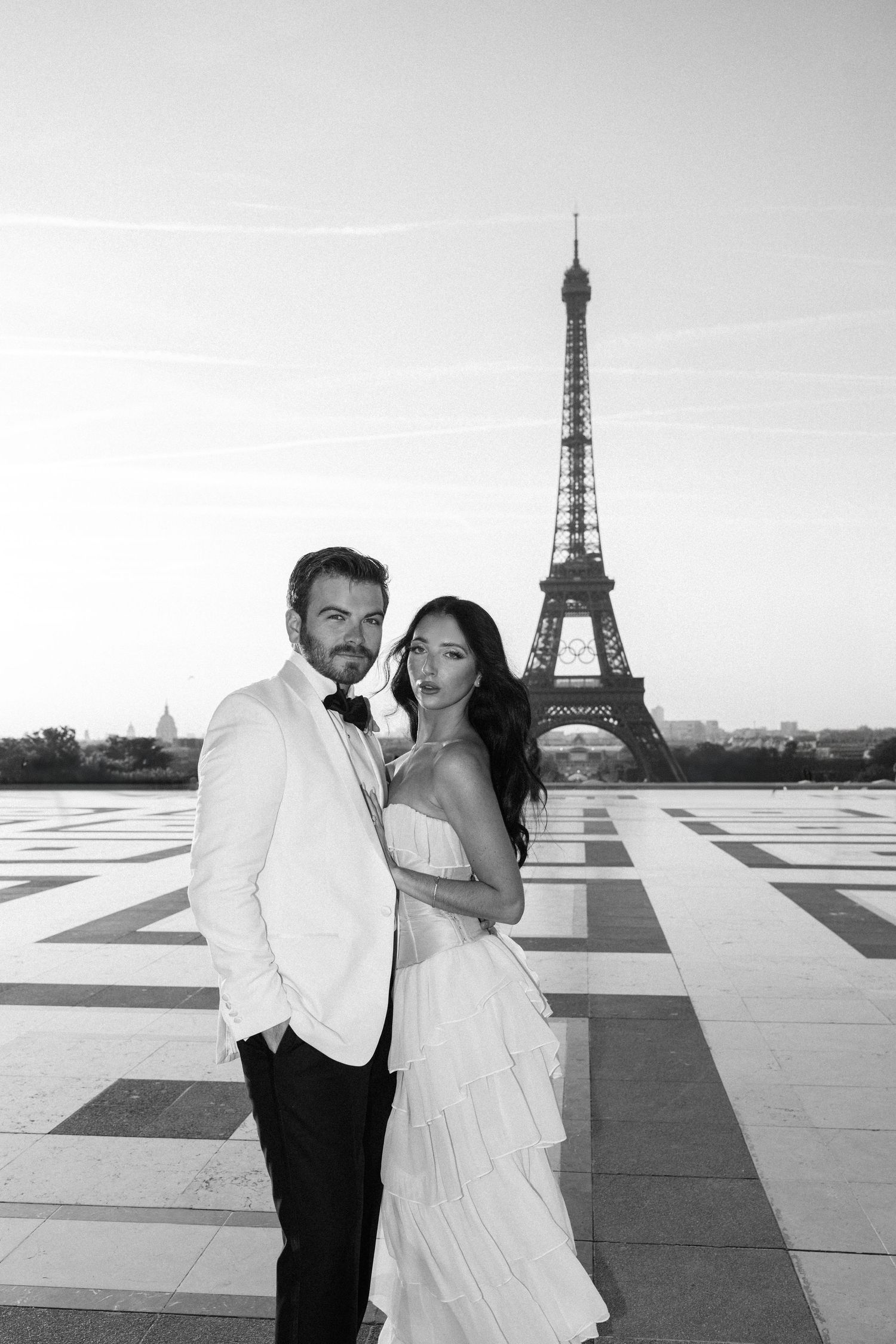 A romantic scene at the Trocadero with the Eiffel Tower in the background and a bird flying past.