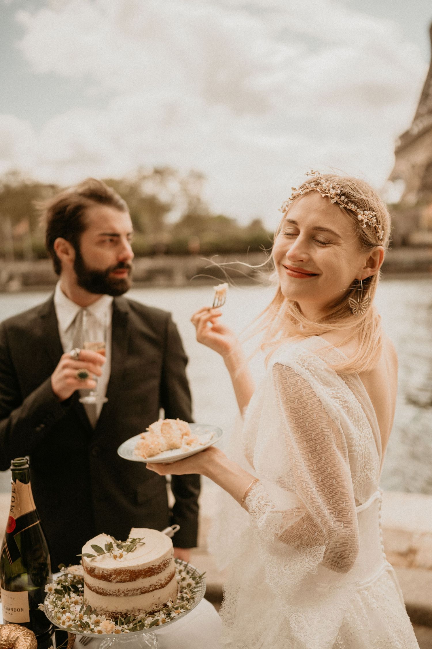 A couple enjoying cake and champagne during their intimate Paris wedding celebration.