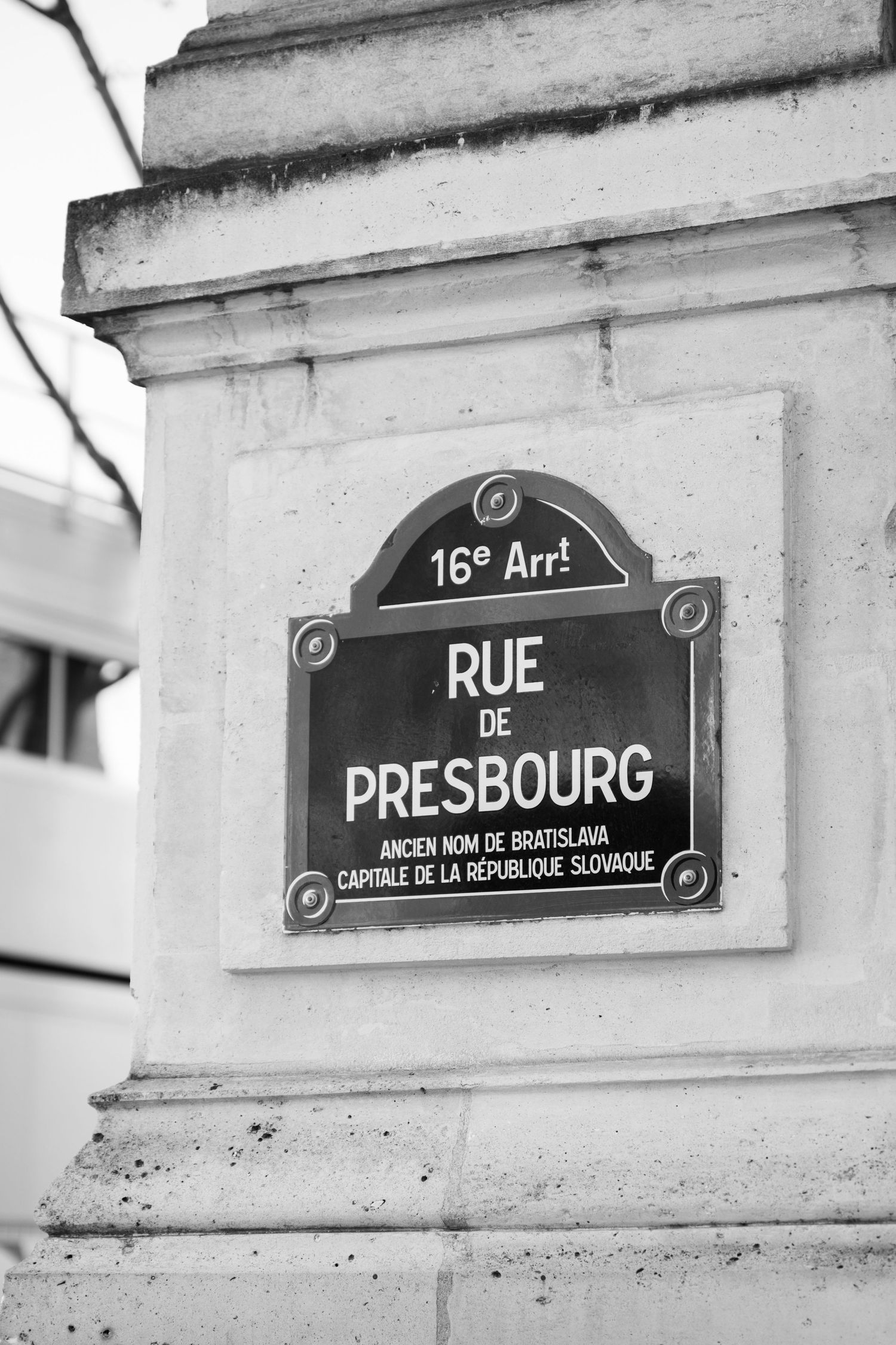 Black and white street sign for Rue de Presbourg in the 16th arrondissement Paris.