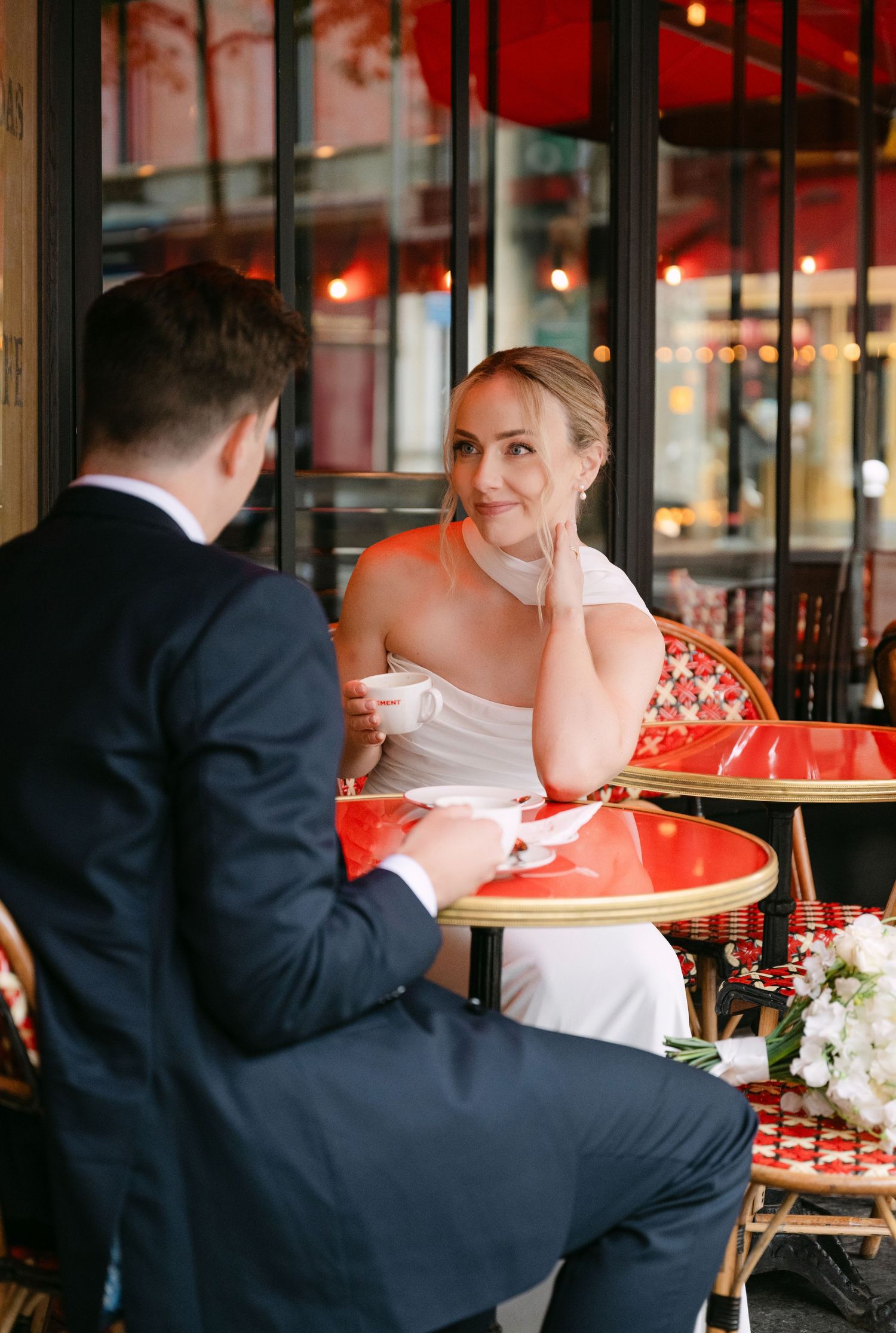 Couple dining at a romantic cafe with red decor and soft lighting, shown in a series of candid moments.