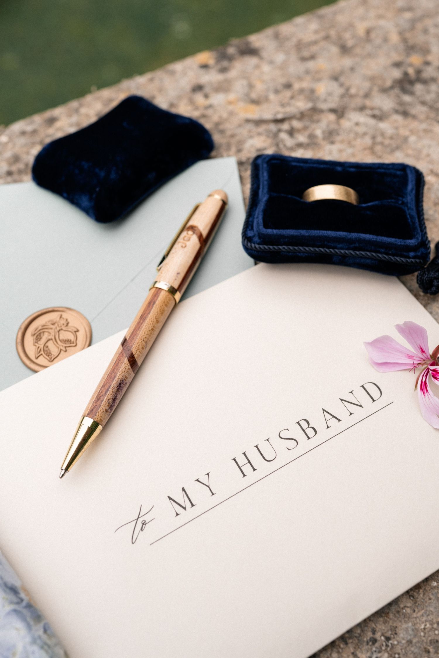 Wedding vow book addressed To My Husband with wooden pen, gold ring in navy velvet box.