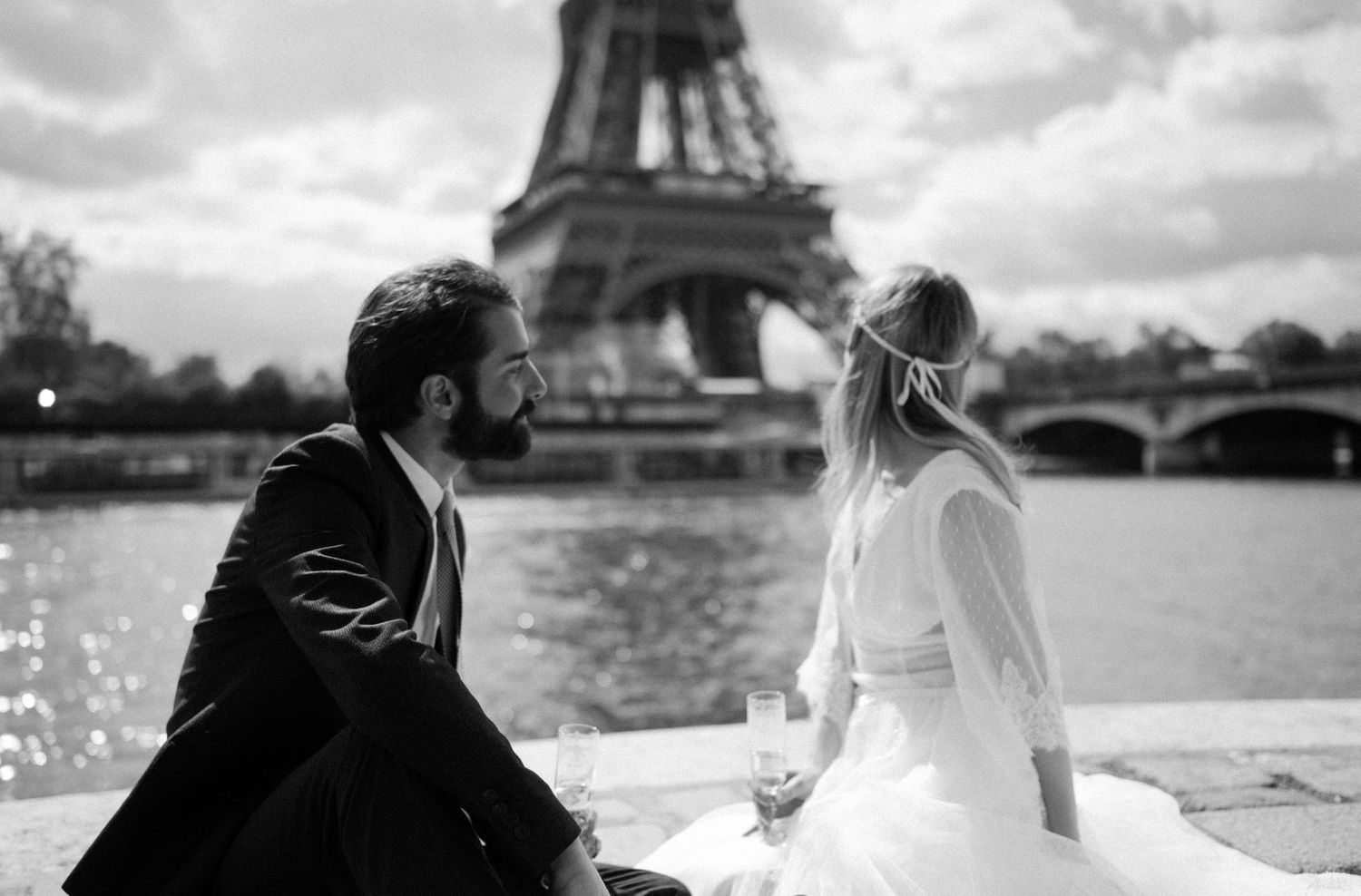 A black and white wedding portrait with the Eiffel Tower and Seine River creating a romantic setting.