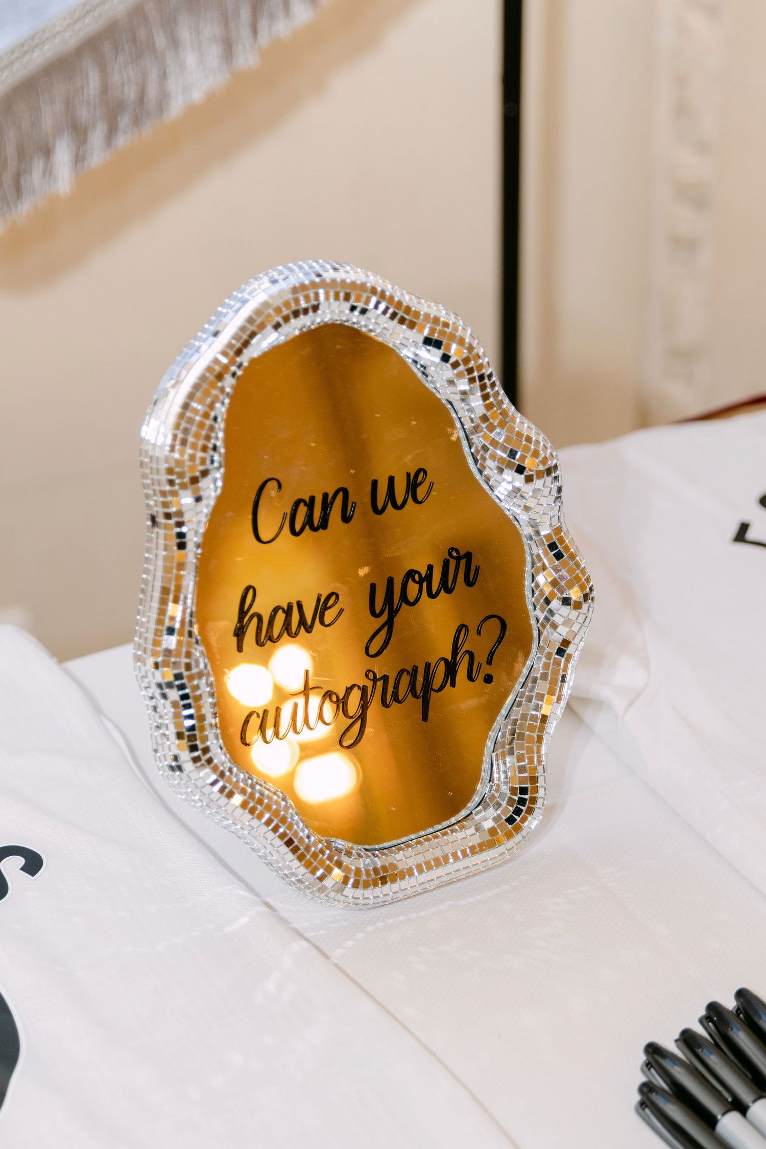 Decorative disco ball mirror sign reading Can we have your autograph at wedding reception.
