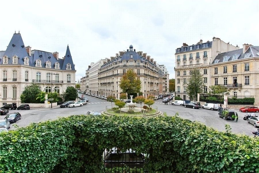 Elegant Parisian neighborhood with classic Haussmanian buildings and tree-lined streets.