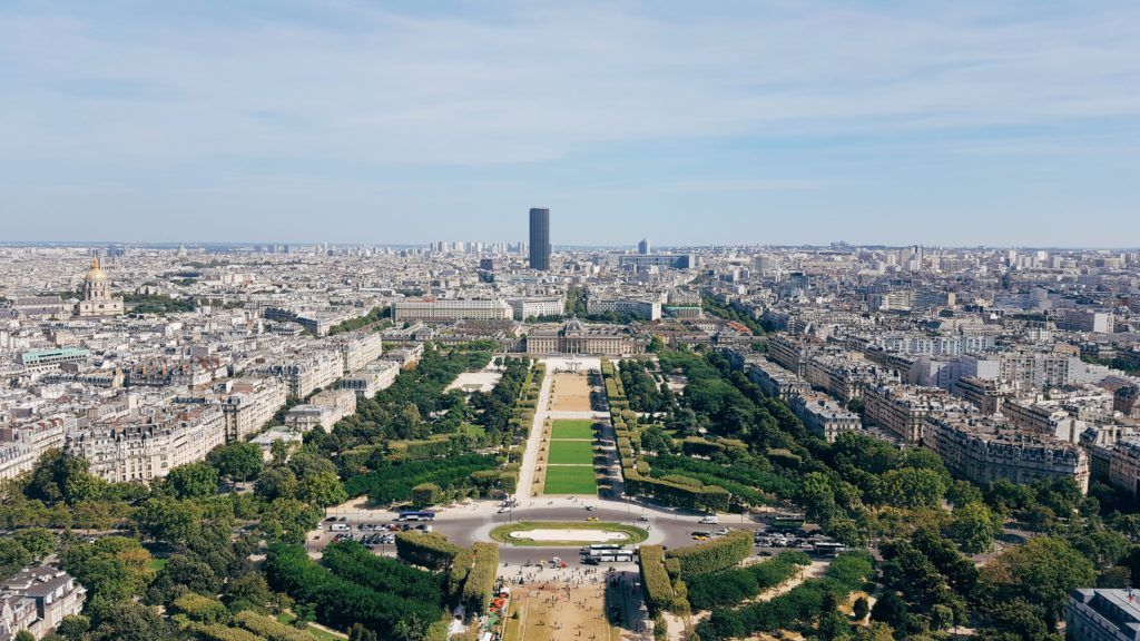 Aerial view of Champ de Mars and Paris cityscape with modern architecture.
