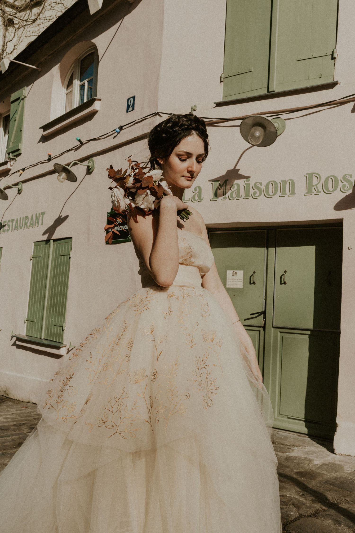 Romantic bridal portrait at La Maison Rose featuring a tulle ballgown and vintage architecture.
