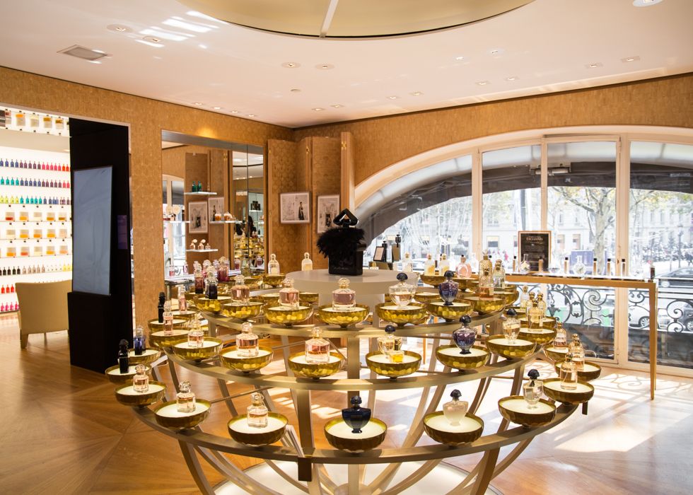 Modern luxury retail display with circular glass shelving showcasing high-end accessories.