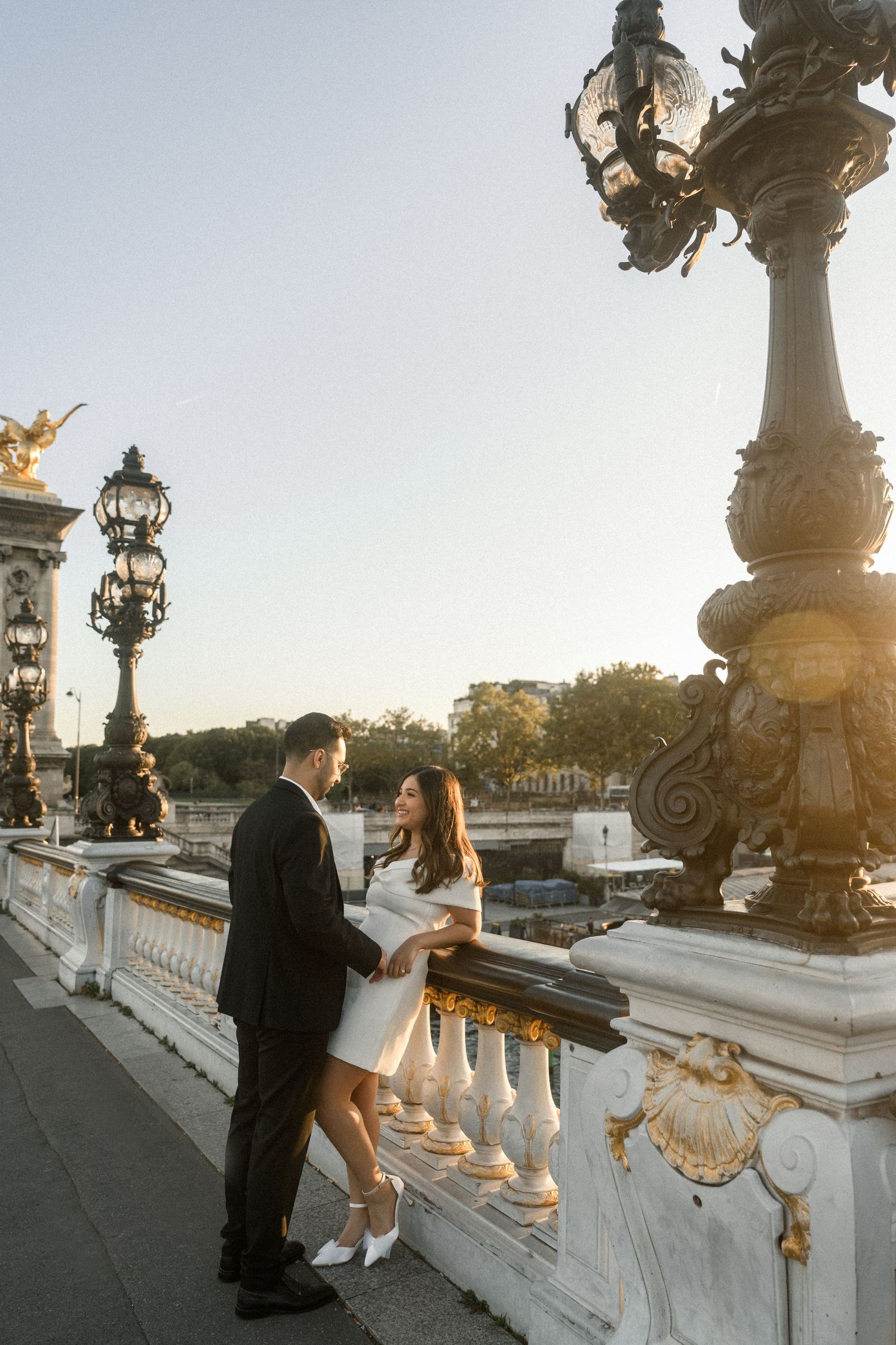A romantic sunset moment on the Alexandre III bridge in Paris.