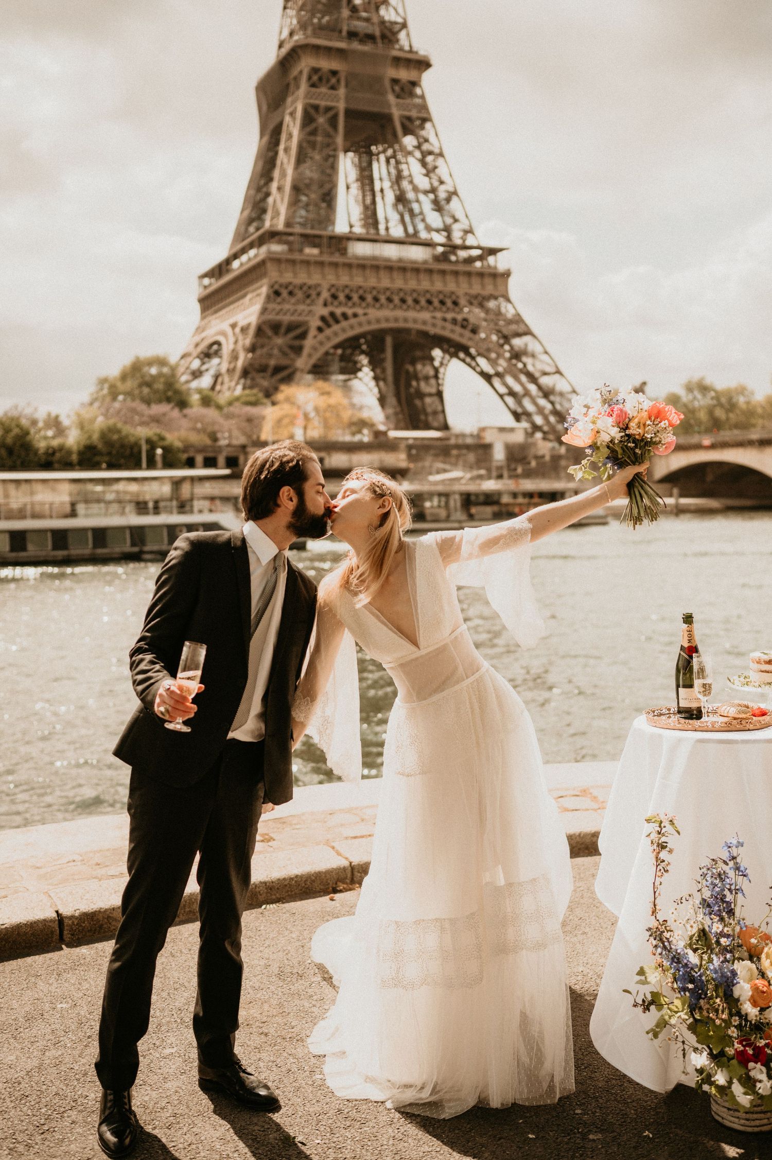 A romantic celebration with champagne and flowers by the Eiffel Tower in Paris.