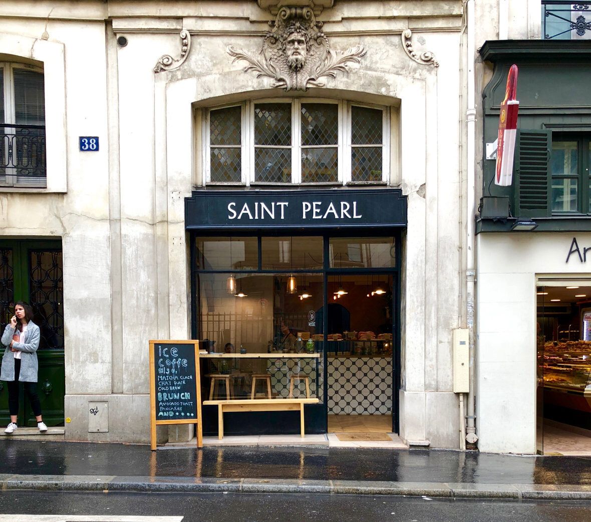 Elegant Parisian storefront with ornate architectural details and Saint Pearl signage.