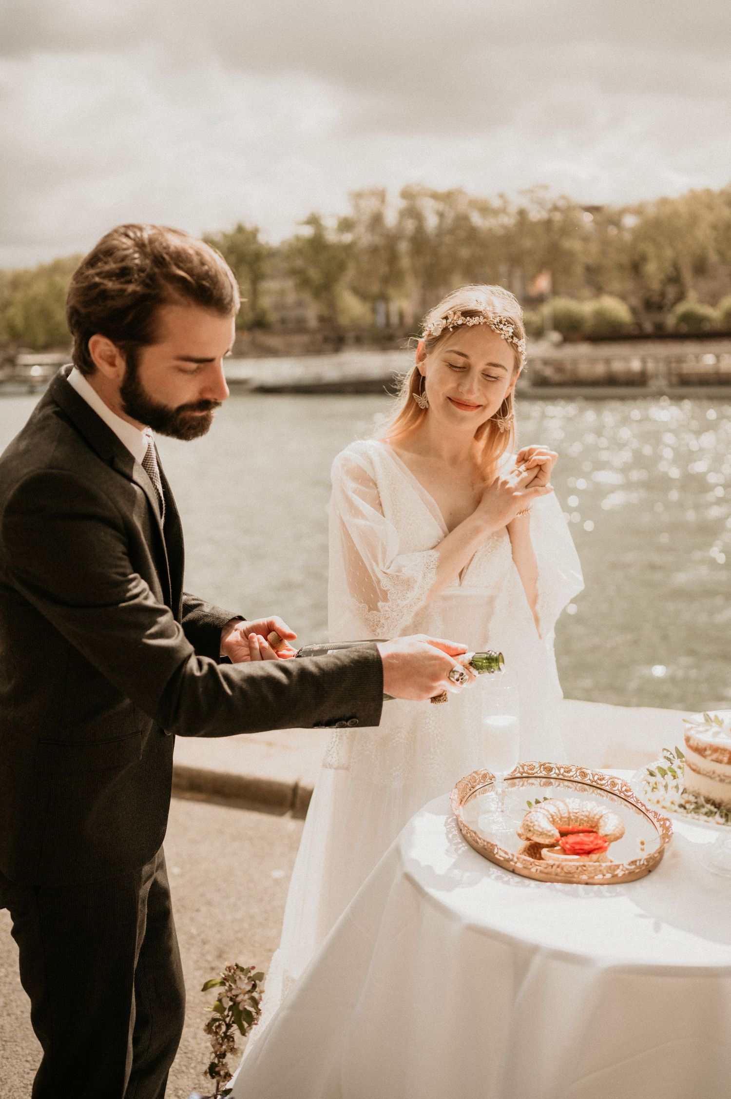 An intimate wedding celebration with champagne and macarons by the Seine River in Paris.