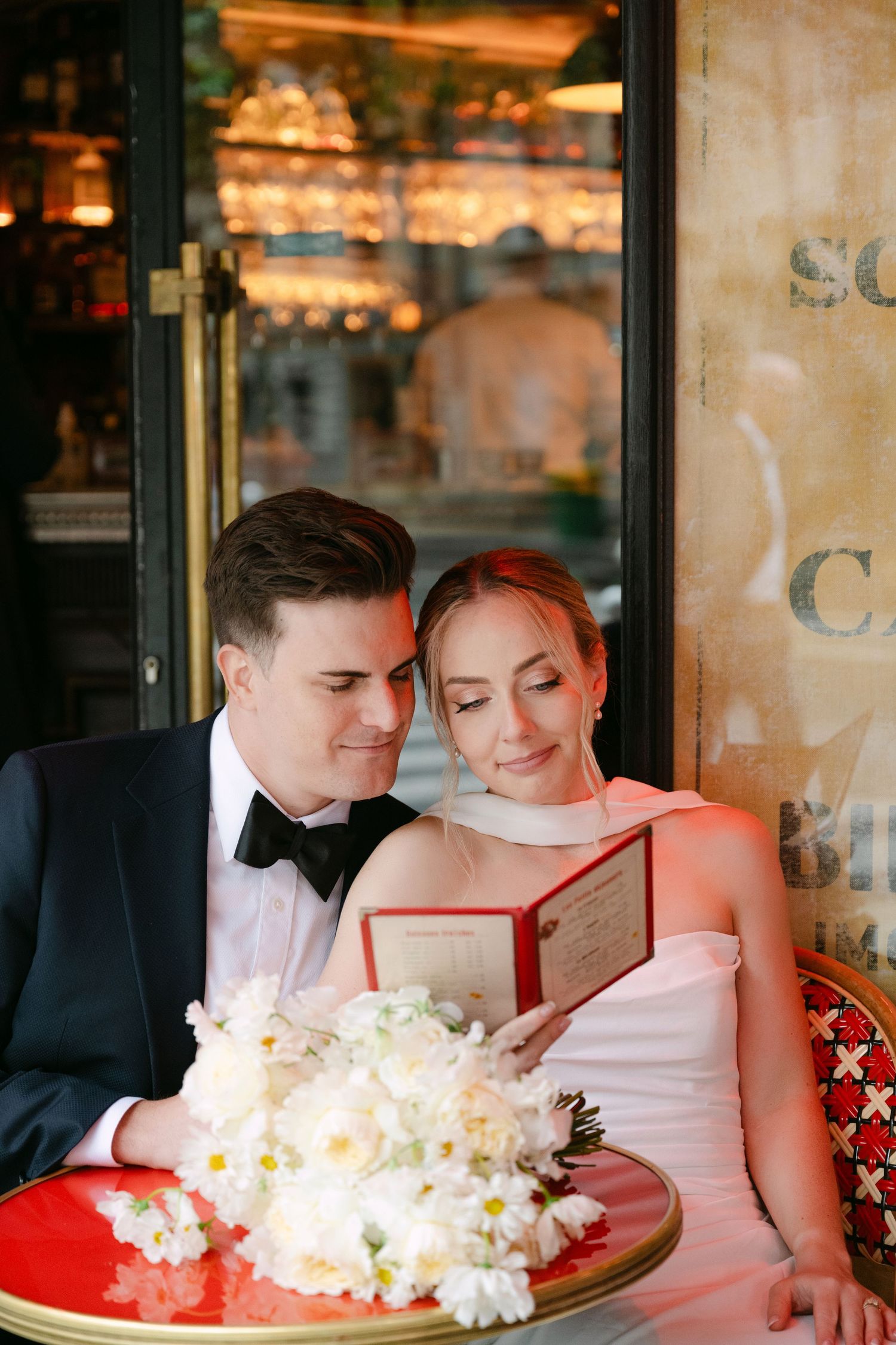 A romantic couple dining at a restaurant sharing dessert in warm lighting.