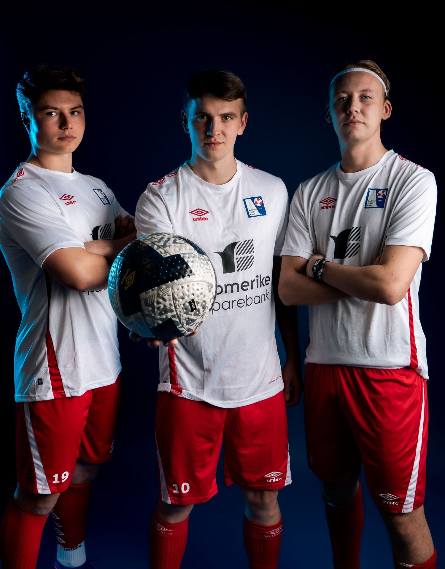 Team players in white and red uniforms pose together for official sports portrait.