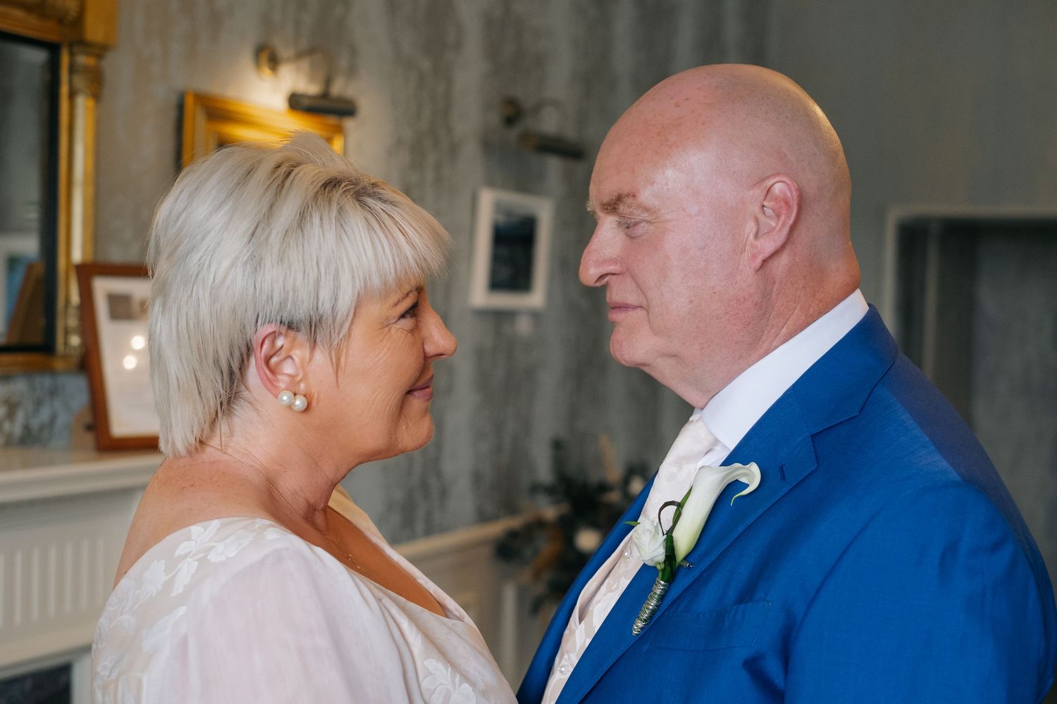 Bride and groom sharing an intimate moment, looking into each others eyes before ceremony.