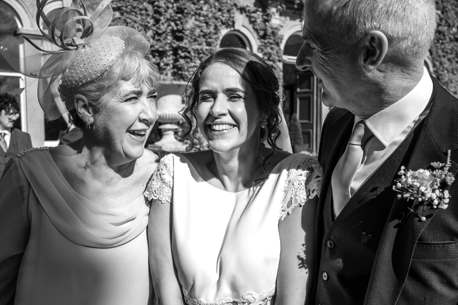 Guests sharing joyful moments during an outdoor wedding celebration.
