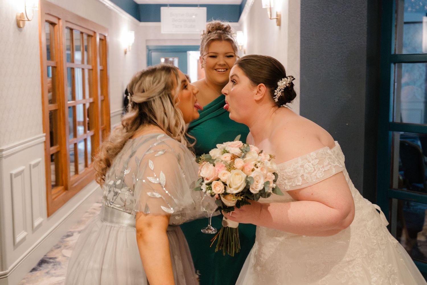Three people share an emotional moment during the wedding celebration.